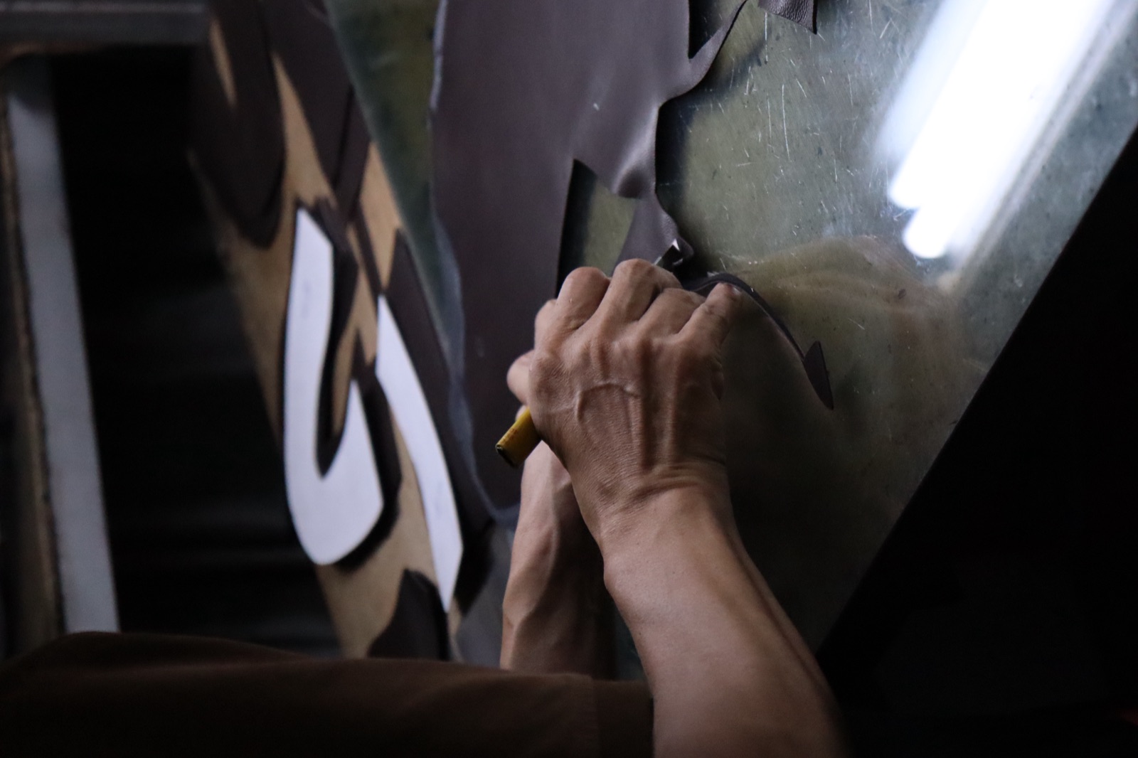 LIDO artisan cutting leather by hand