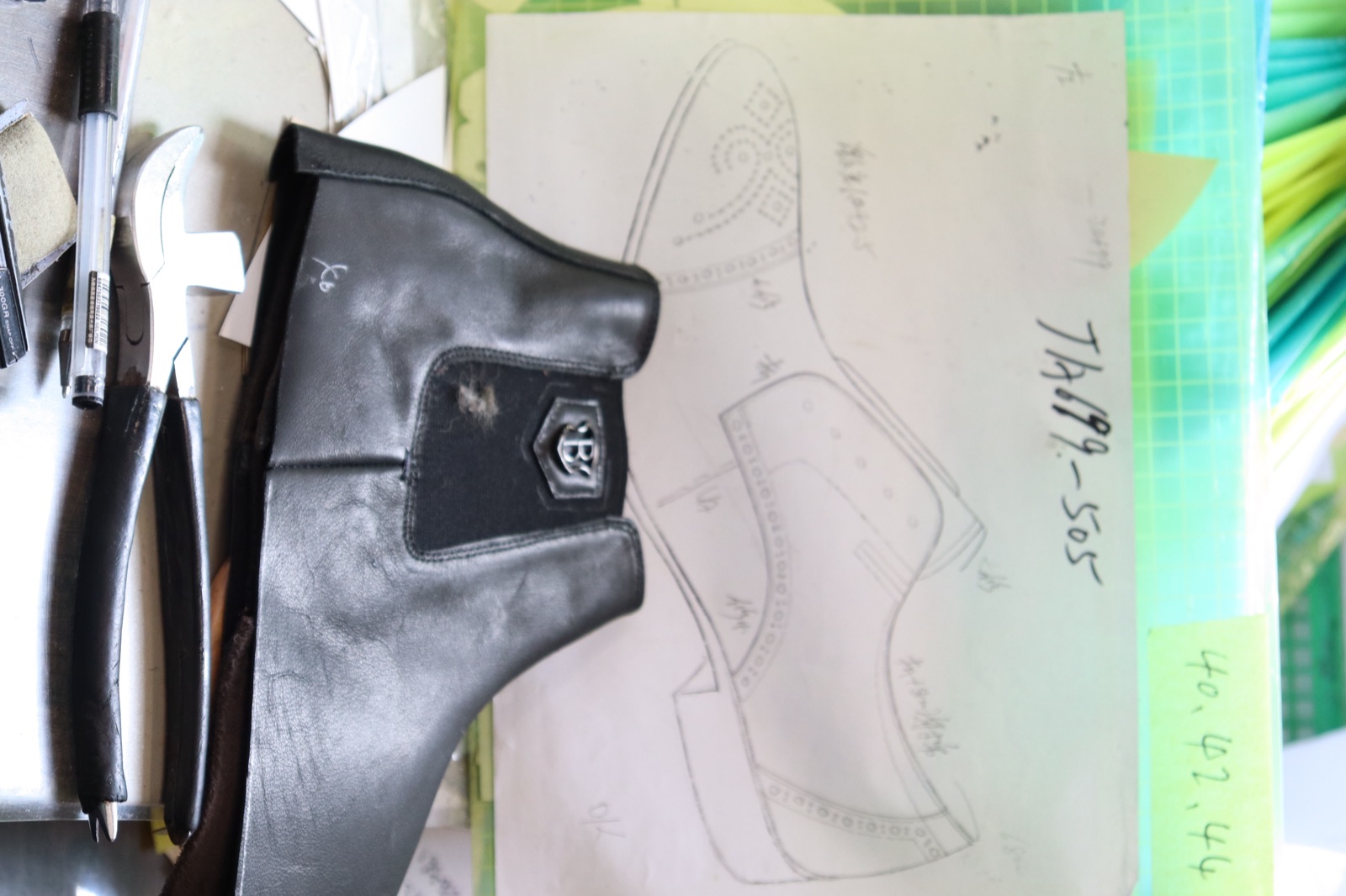 Pattern desk with prototype boot and hand-drawn design
